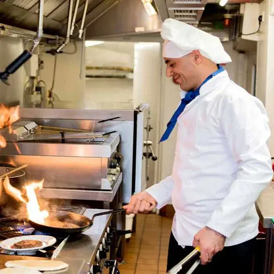 Meadowlark Estates Chef Created Meals, chef frying a dish.