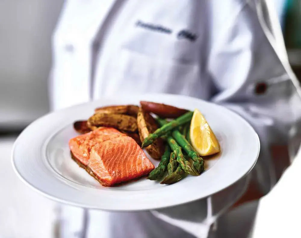 Meadowlark Estates Chef Created Meals, chef delivering a finished dish.
