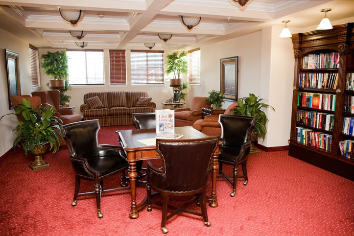 The library at Meadowlark Estates with shelves of books and comfortable seating
