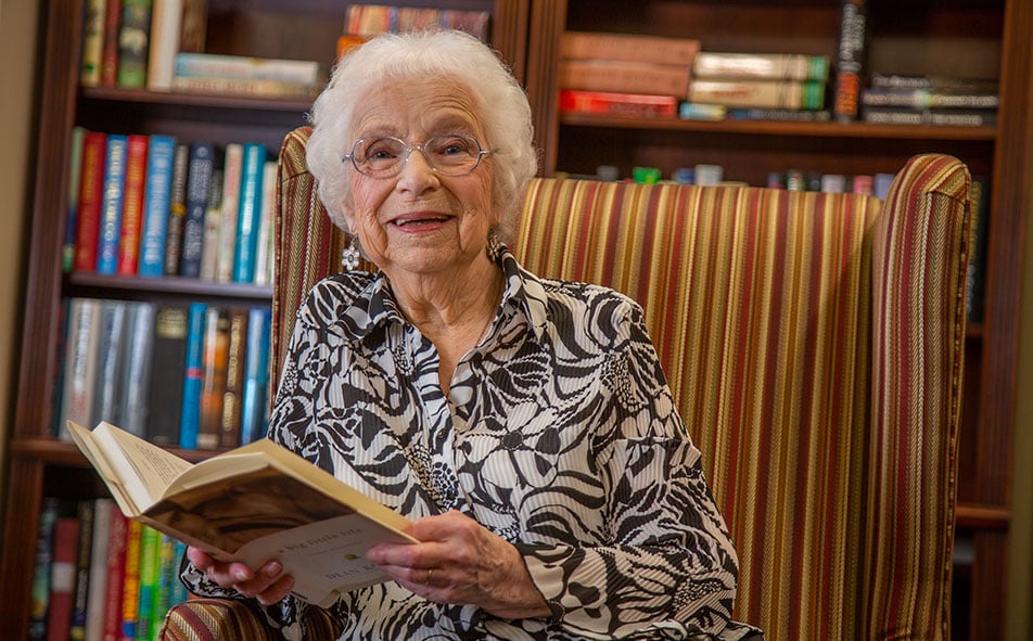 The library at Meadowlark Estates with shelves of books and comfortable seating